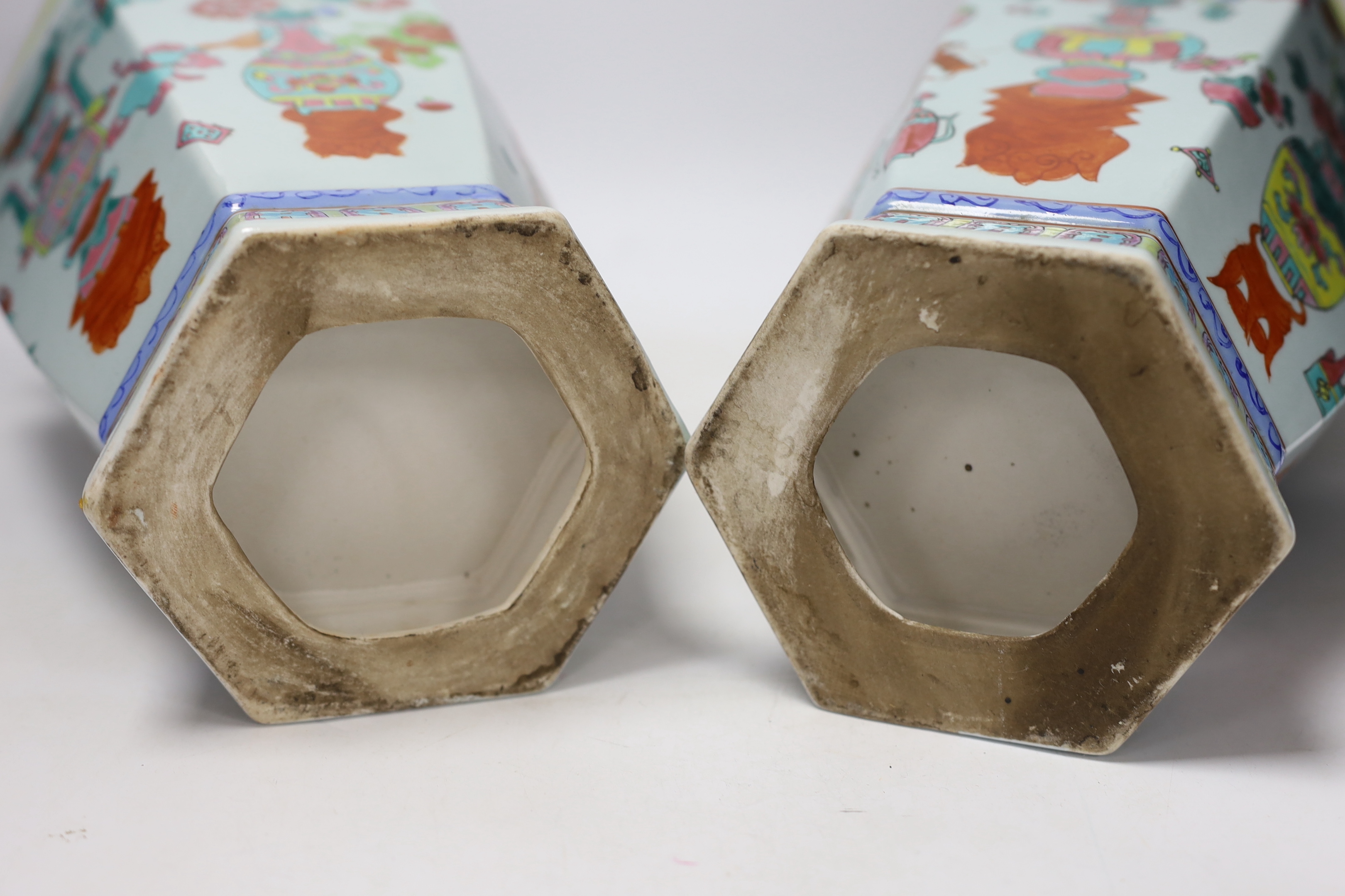 A pair of Chinese famille rose vases and a similar jar and cover, 38cm